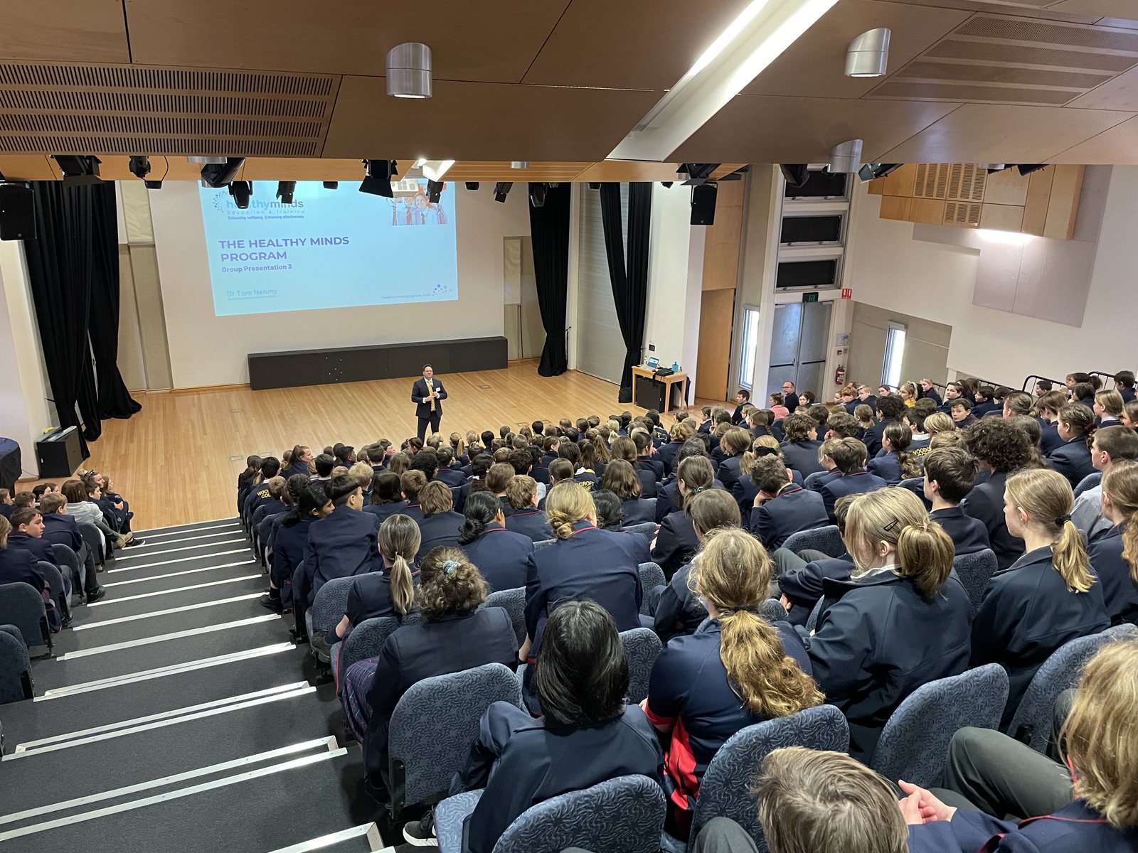Dr Tom Nehmy presenting the Healthy Minds program to hundreds of students at Woodcroft College
